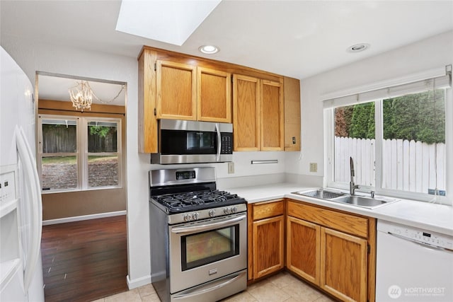 13940 113th Ave NE, Kirkland, WA 98034 - kitchen with stainless steel appliances, a chandelier, light countertops, recessed lighting, and a skylight