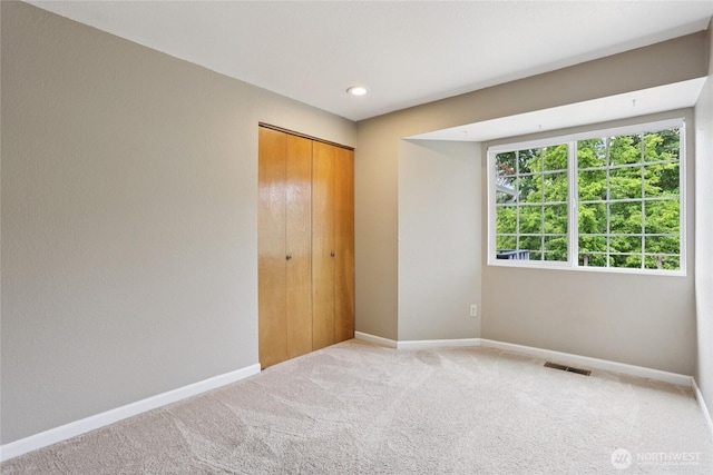 13940 113th Ave NE, Kirkland, WA 98034 - unfurnished bedroom with carpet floors, a closet, and recessed lighting