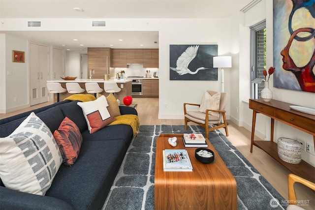 583 Battery St Unit 212N, Seattle, WA 98121 - living area featuring light wood-type flooring and recessed lighting