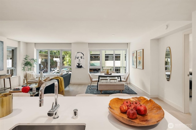 583 Battery St Unit 212N, Seattle, WA 98121 - kitchen with open floor plan, light wood-type flooring, and light countertops