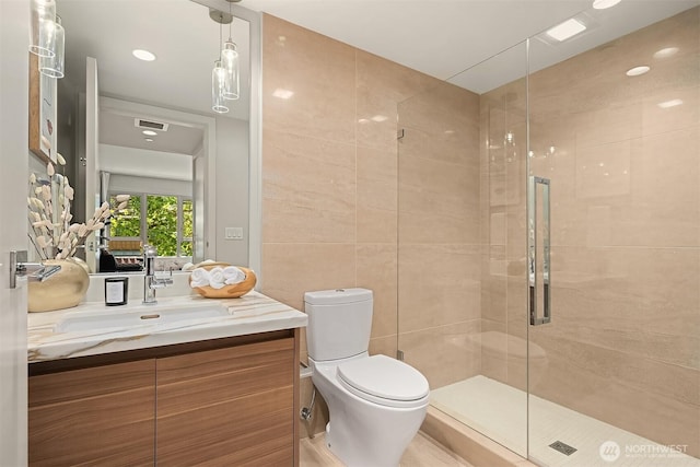 583 Battery St Unit 212N, Seattle, WA 98121 - full bath featuring vanity, a stall shower, and tile walls