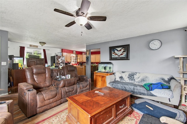 304 Harris St, Kelso, WA 98626 - living room featuring a textured ceiling, ceiling fan, and light wood-style flooring