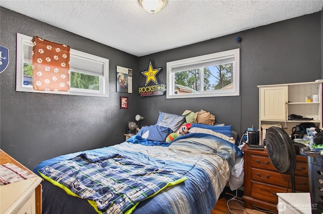 304 Harris St, Kelso, WA 98626 - bedroom featuring a textured ceiling, a textured wall, and wood finished floors