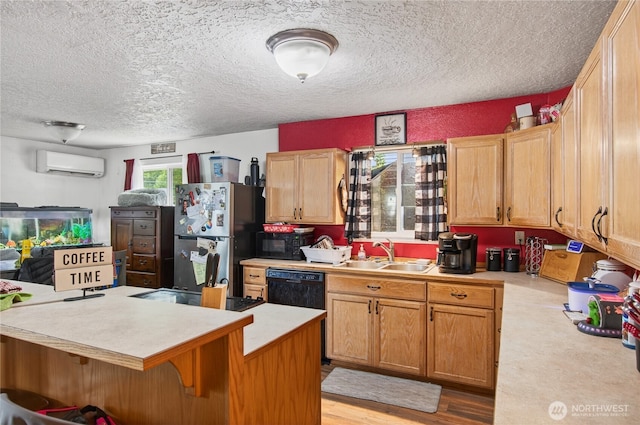 304 Harris St, Kelso, WA 98626 - kitchen featuring a wall unit AC, freestanding refrigerator, light countertops, black dishwasher, and a textured ceiling