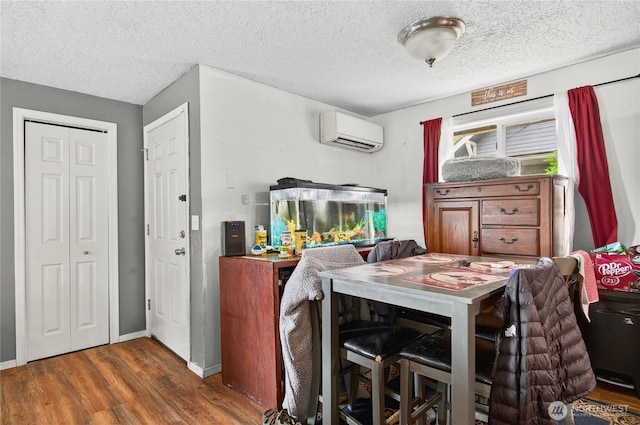 304 Harris St, Kelso, WA 98626 - dining space with a wall mounted air conditioner, wood finished floors, and a textured ceiling