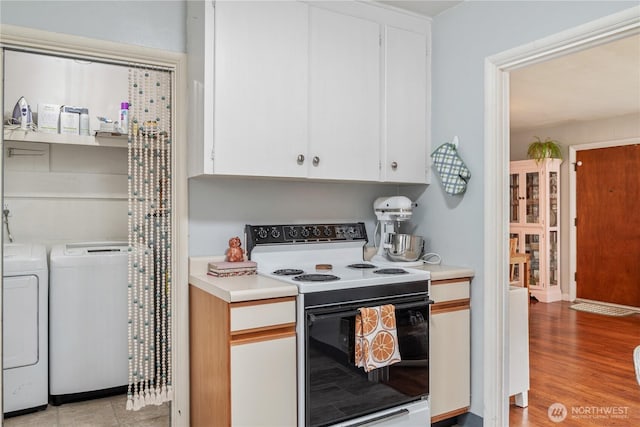 11341136 16th Ave, Longview, WA 98632 - kitchen with electric stove, washer and clothes dryer, light countertops, and white cabinets