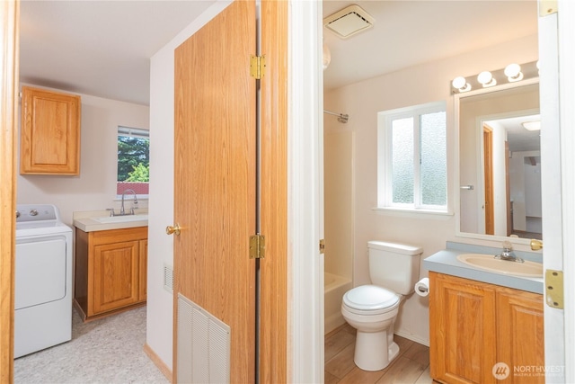2289 Towne Point Ave, Port Townsend, WA 98368 - full bath featuring washer / clothes dryer, vanity, bathtub / shower combination, and plenty of natural light