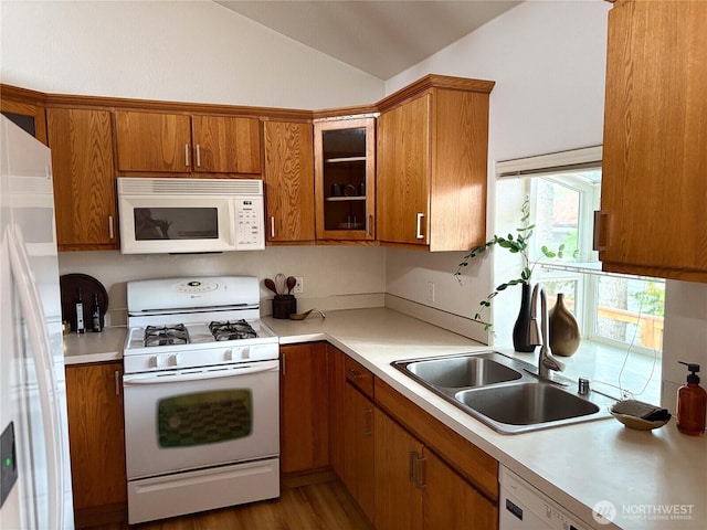 933 Fern St SW, Olympia, WA 98502 - kitchen featuring white appliances, vaulted ceiling, brown cabinetry, and light countertops