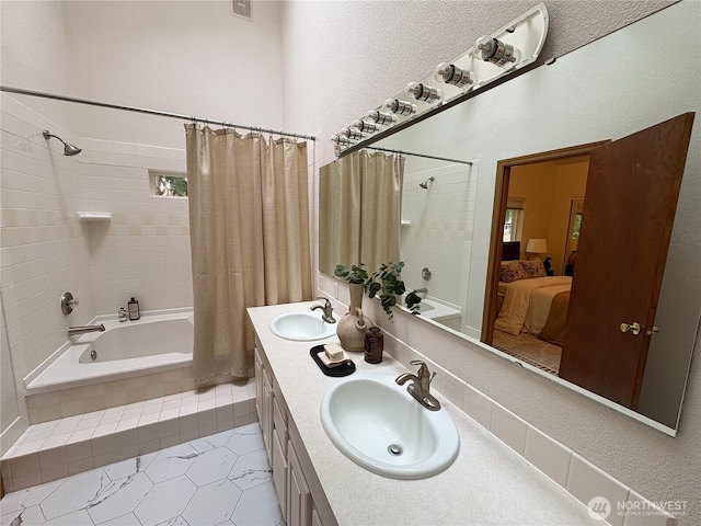 933 Fern St SW, Olympia, WA 98502 - ensuite bathroom with tiled shower / bath combo, double vanity, tile patterned flooring, and a textured wall