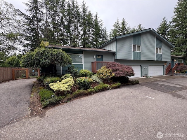 933 Fern St SW, Olympia, WA 98502 - tri-level home featuring driveway, an attached garage, and stairway