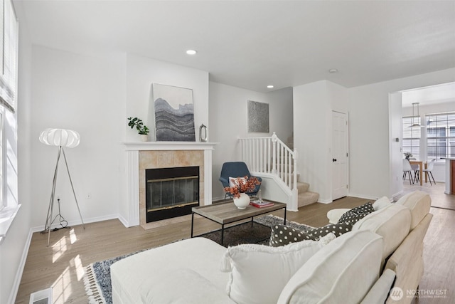 352 227th Ln NE Unit 142, Sammamish, WA 98074 - living area featuring wood finished floors, stairs, a fireplace, and recessed lighting