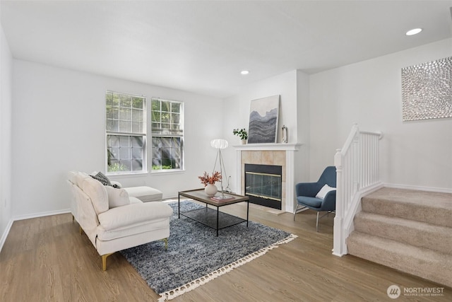 352 227th Ln NE Unit 142, Sammamish, WA 98074 - living room featuring wood finished floors, a tiled fireplace, stairs, and recessed lighting