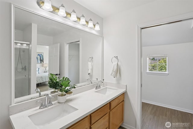 352 227th Ln NE Unit 142, Sammamish, WA 98074 - bathroom with double vanity, wood finished floors, and a shower with door