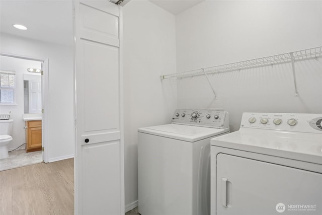 352 227th Ln NE Unit 142, Sammamish, WA 98074 - laundry area featuring independent washer and dryer and light wood-style flooring