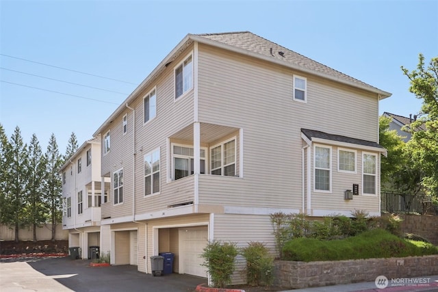 352 227th Ln NE Unit 142, Sammamish, WA 98074 - view of property exterior featuring a garage and a shingled roof