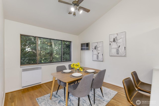 6367 Sand Point Way NE, Seattle, WA 98115 - dining area featuring radiator, ceiling fan, wood finished floors, high vaulted ceiling, and a wall mounted AC
