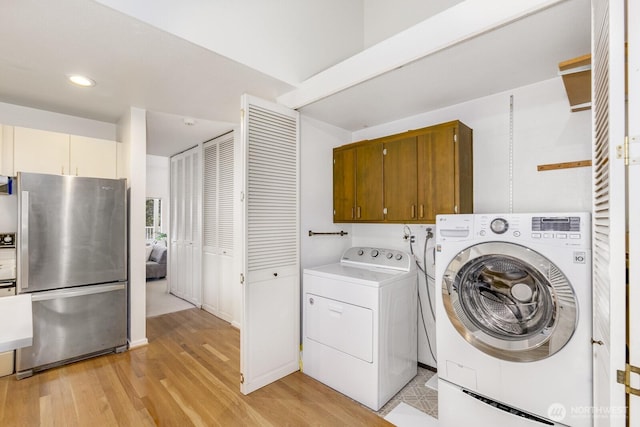 6367 Sand Point Way NE, Seattle, WA 98115 - laundry area with recessed lighting, washing machine and dryer, and light wood-type flooring
