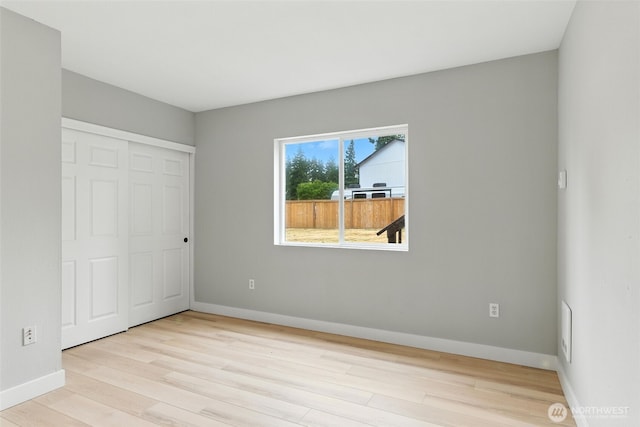 21905 128th St E, Bonney Lake, WA 98391 - unfurnished bedroom with wood finished floors and a closet