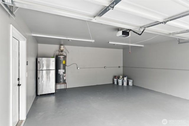 21905 128th St E, Bonney Lake, WA 98391 - garage with freestanding refrigerator, water heater, and a garage door opener