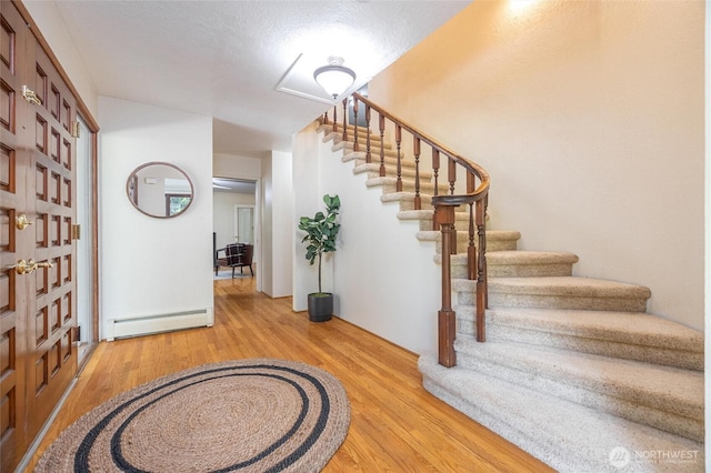 3928 Sorenson Rd, Everson, WA 98247 - foyer entrance with baseboard heating, light wood-style flooring, and stairs