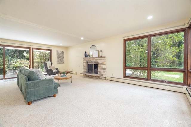 3928 Sorenson Rd, Everson, WA 98247 - carpeted living room with a baseboard heating unit, plenty of natural light, a stone fireplace, and recessed lighting