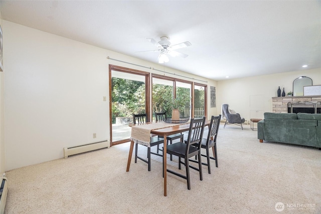 3928 Sorenson Rd, Everson, WA 98247 - dining area featuring a baseboard radiator, ceiling fan, light colored carpet, and baseboard heating