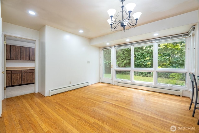 3928 Sorenson Rd, Everson, WA 98247 - unfurnished dining area with a baseboard heating unit, a chandelier, light wood-type flooring, and recessed lighting