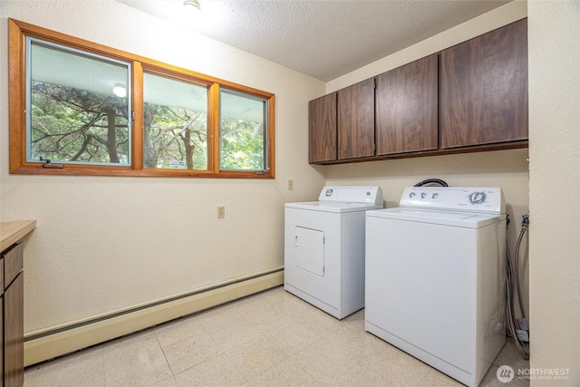 3928 Sorenson Rd, Everson, WA 98247 - laundry room with baseboard heating, cabinet space, healthy amount of natural light, washer and clothes dryer, and a textured ceiling