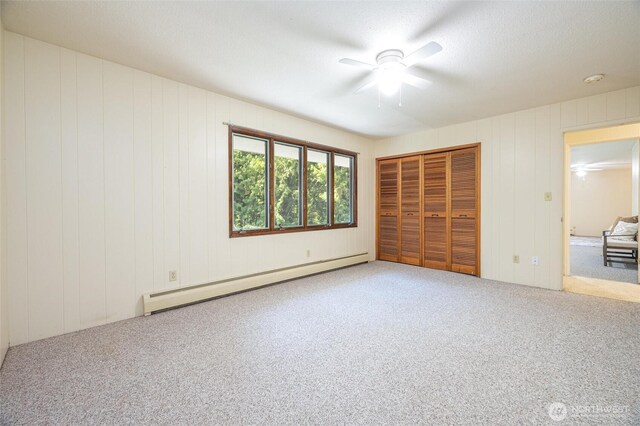 3928 Sorenson Rd, Everson, WA 98247 - unfurnished bedroom featuring a baseboard heating unit, carpet floors, a closet, and a ceiling fan