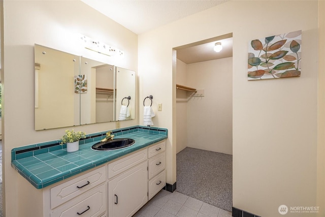 3928 Sorenson Rd, Everson, WA 98247 - bathroom with vanity, tile patterned flooring, and a walk in closet