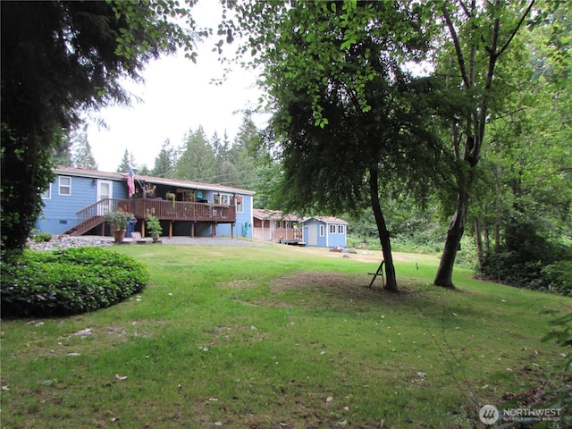 4917 107th Ave SE, Snohomish, WA 98290 - view of green lawn featuring a wooden deck, a storage unit, and stairs