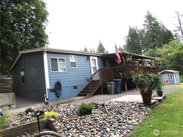 4917 107th Ave SE, Snohomish, WA 98290 - view of front of house featuring a storage shed, crawl space, a deck, and a patio