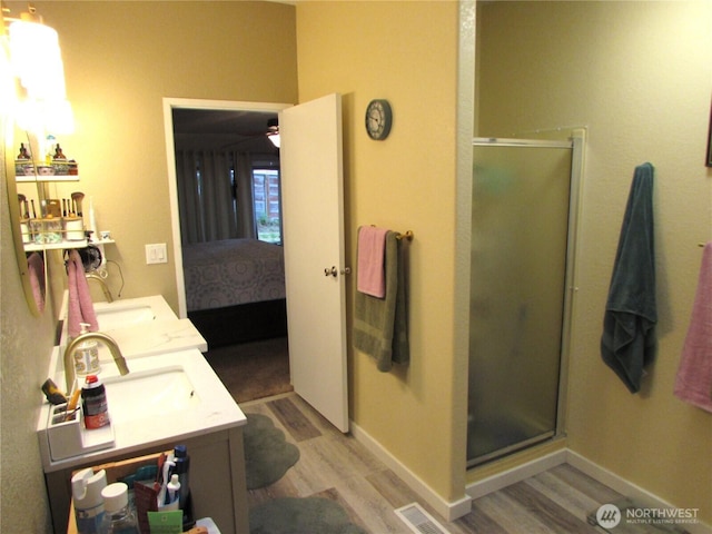 4917 107th Ave SE, Snohomish, WA 98290 - ensuite bathroom with wood finished floors, a stall shower, and double vanity