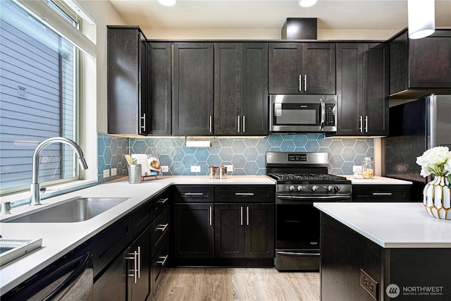 6855 NE 170th St Unit 102, Kenmore, WA 98028 - kitchen with stainless steel appliances, light wood finished floors, light countertops, and tasteful backsplash