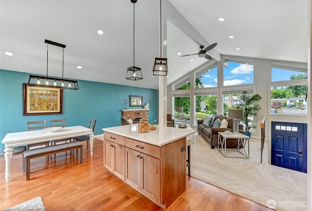 13506 89th Pl NE, Kirkland, WA 98034 - kitchen featuring ceiling fan, open floor plan, light wood-style floors, light countertops, and a kitchen island