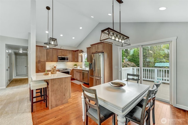 13506 89th Pl NE, Kirkland, WA 98034 - dining space with light wood-style floors, recessed lighting, and high vaulted ceiling