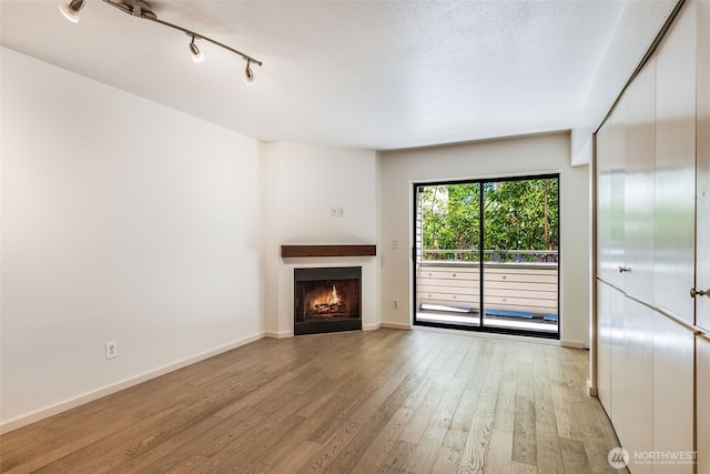 211 E Summit Ave Unit S117, Seattle, WA 98102 - unfurnished living room with a warm lit fireplace and light wood-type flooring
