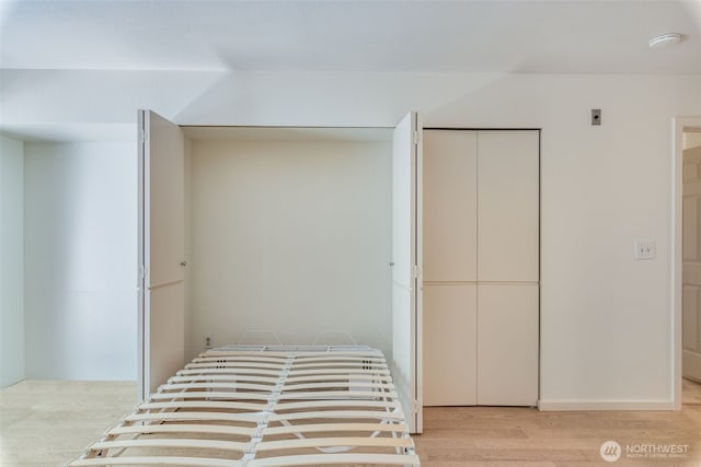 211 E Summit Ave Unit S117, Seattle, WA 98102 - unfurnished bedroom featuring light wood-style flooring and a closet