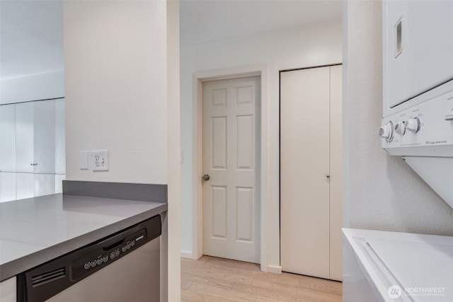 211 E Summit Ave Unit S117, Seattle, WA 98102 - washroom featuring stacked washer and clothes dryer and light wood-type flooring