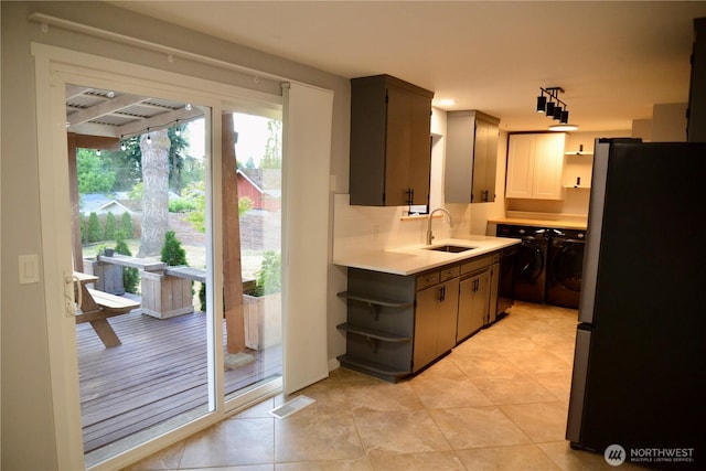 30135 2nd Ave SW, Federal Way, WA 98023 - kitchen with freestanding refrigerator, open shelves, washer and clothes dryer, light countertops, and light tile patterned flooring