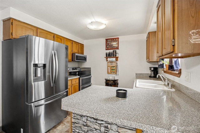 17112 Kinnikinnick Ct SE, Yelm, WA 98597 - kitchen with stainless steel appliances, a peninsula, brown cabinetry, and light countertops