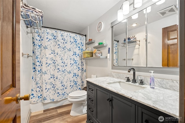 17112 Kinnikinnick Ct SE, Yelm, WA 98597 - bathroom with wood finished floors, vanity, and shower / tub combo
