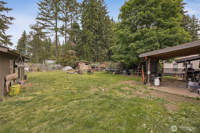 17112 Kinnikinnick Ct SE, Yelm, WA 98597 - fenced backyard featuring a trampoline, a shed, and a patio area