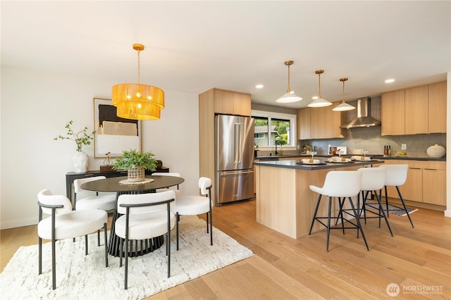 21 165th Ave SE, Bellevue, WA 98008 - kitchen with high end refrigerator, wall chimney exhaust hood, light brown cabinetry, modern cabinets, and recessed lighting