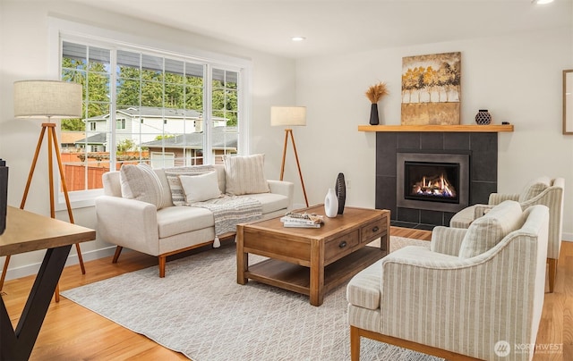 8004 203rd Pl SW, Edmonds, WA 98026 - living area with wood finished floors, a tiled fireplace, and recessed lighting
