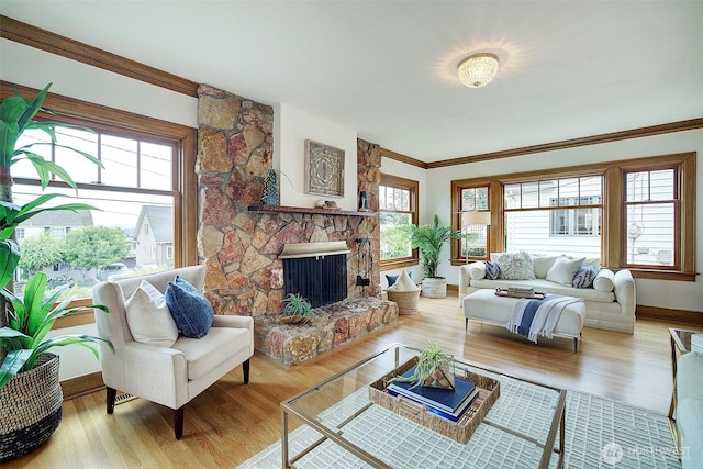 2663 37th Ave SW, Seattle, WA 98126 - living area featuring wood finished floors, crown molding, and a stone fireplace