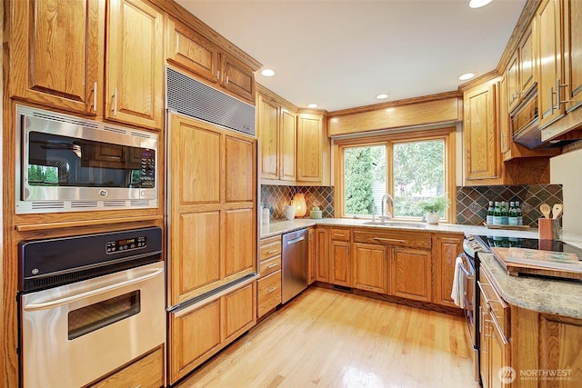 2663 37th Ave SW, Seattle, WA 98126 - kitchen with built in appliances, light wood finished floors, light stone countertops, backsplash, and recessed lighting
