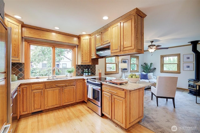 2663 37th Ave SW, Seattle, WA 98126 - kitchen featuring stainless steel electric stove, a wood stove, light wood-type flooring, a peninsula, and recessed lighting