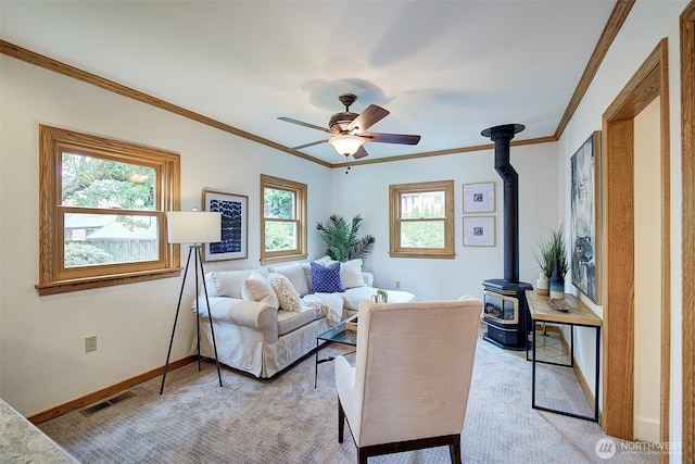 2663 37th Ave SW, Seattle, WA 98126 - living area featuring a wood stove, crown molding, a ceiling fan, and light carpet