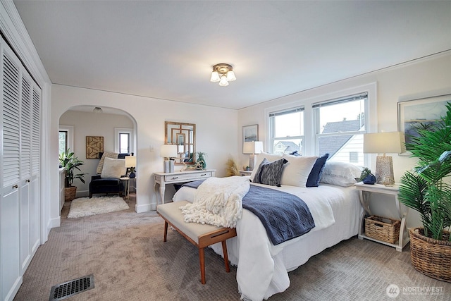 2663 37th Ave SW, Seattle, WA 98126 - bedroom with arched walkways, multiple windows, light carpet, and a closet